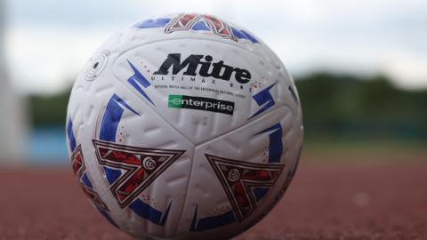 A National League match ball on an athletics track