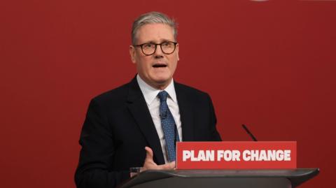 Sir Keir Starmer gives a speech behind a podium reading: "Plan for change"