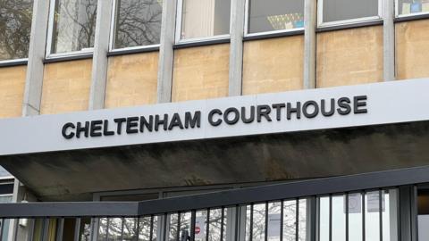 The sign above Cheltenham Magistrates' Court door, which reads "Cheltenham Courthouse" in black lettering