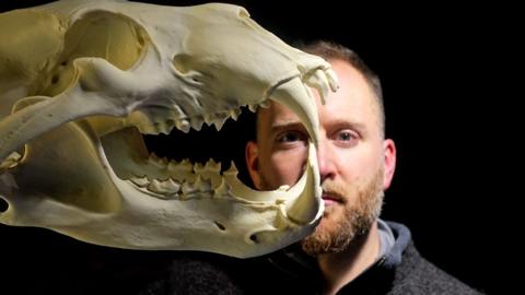 Calum Maclean behind a skull
