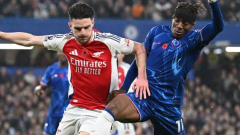 Arsenal's Declan Rice competes with former Chelsea player Noni Madueke
