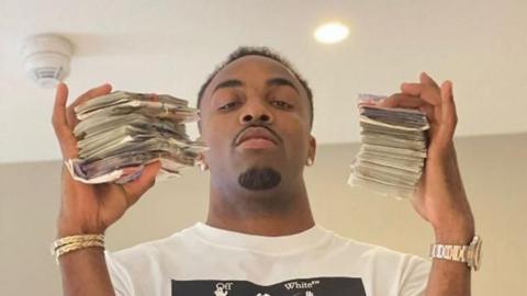 Davante James is holding wads of cash