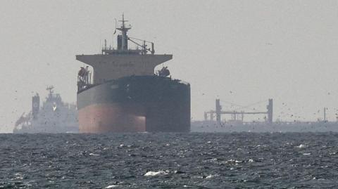 Tankers sail in the Gulf, near the Strait of Hormuz, as seen from northern Ras al-Khaimah, near the border with Oman’s Musandam governance