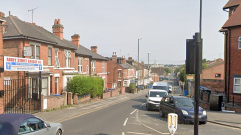 Abbey Street in Derby with cars rounding a corner