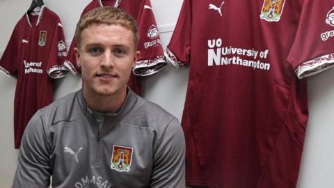 Footballer Liam McCarron signing for Northampton Town