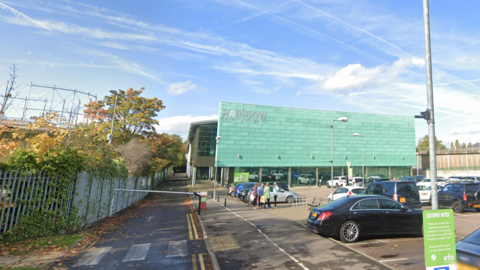 An exterior view of Rainbow Leisure Centre on Epsom taken from its car park