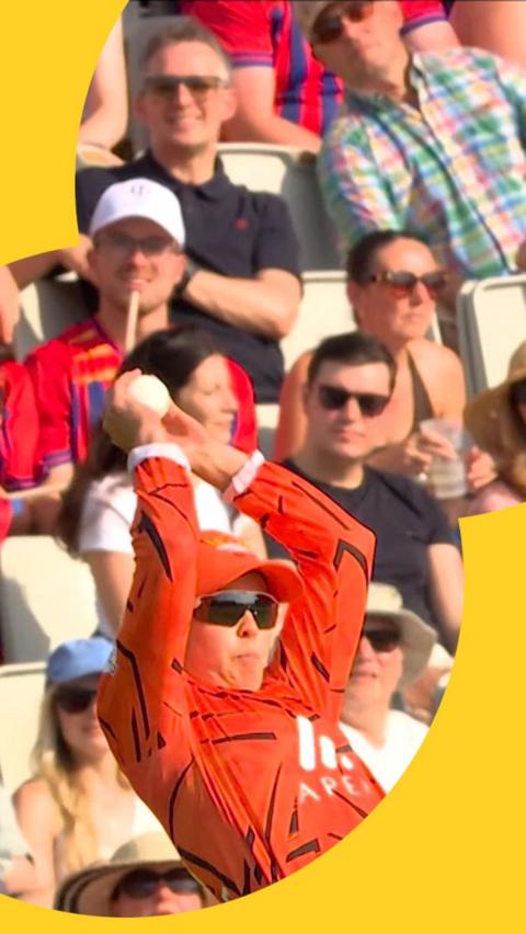Phoebe Litchfield leaps backwards to make an incredible stop as the crowd behind her watch on