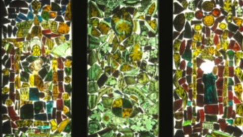 A design of how the window panels will look - a mixture of deep greens with hues of amber and red culminate together into three abstract designs.