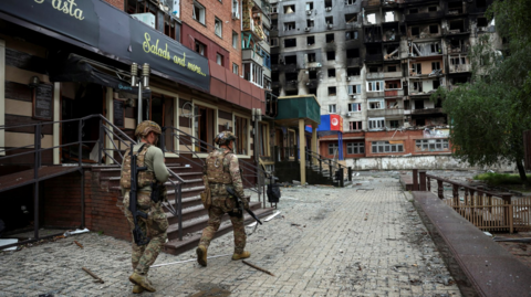 Members of the White Angel unit of Ukrainian police officers who evacuate people from the frontline towns and villages, check an area for residents, amid Russia's attack on Ukraine, in the frontline town of Pokrovsk in Donetsk region, on 21 May 2025.
