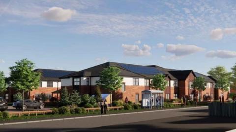 An artist's impression of a two-storey care home. It has brown brick with a white finish and a grey roof with solar panels. A number of trees can also be seen at the front of the development. 