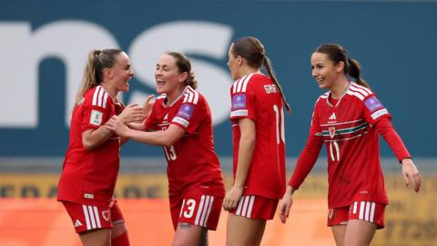 Lily Woodham, Rachel Rowe, Mared Griffiths and Hannah Cain celebrate Wales' fifth goal
