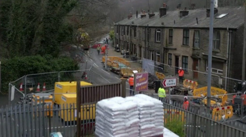 A shot of a busy road near Hebden Bridge with road works 