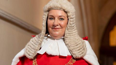 Lady Chief Justice stood in the centre of the picture, wearing ceremonial robes and a traditional judges' wig