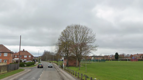 Road with a park on the right hand side