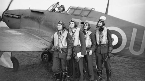 A black and white image of five airmen standing behind a Hawker Hurricane fighter jet in 1940 on an airfield in East Yorkshire.