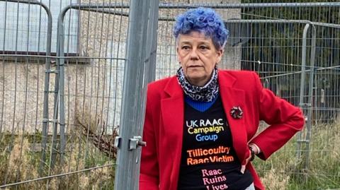 Frances Reid standing outside the flats 