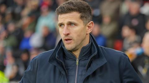 Disappointed Portsmouth boss John Mousinho on the touchline at Bramall Lane