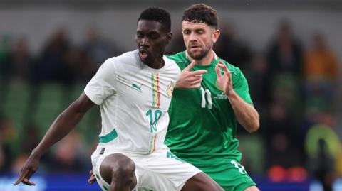 Ismaila Sarr in action with Robbie Brady