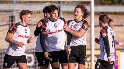 Ben Ahmun celebrates with his Haverfordwest team-mates after securing a point for his side with a late penalty at Connah's Quay Nomads