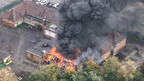 aerial close-up of fire at former school