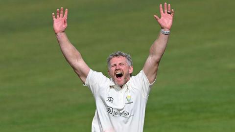 Glamorgan bowler Timm van der Gugten throws his arms up in the air as he appeals for a decision
