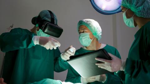 Doctors performing an operation using VR goggles