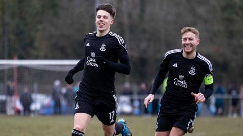 Rhys Hughes (left) celebrates after giving Connah's Quay the lead against Caerau Ely