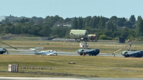 small white plane on runway