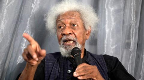 Wole Soyinka, a Nobel Laureate, gestures while speaking to a microphone
