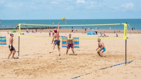 Four people play beach volleyball in Margate, Kent, on 15 June 2025