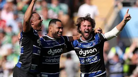 Joe Cokanasiga of Bath Rugby and team mates Max Ojomoh and Tom de Glanville celebrate at the final whistle after winning the Gallagher Premiership Rugby Final match between Bath Rugby and Leicester Tigers