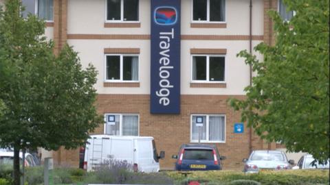 Outside of a Travelodge building with white walls and brickwork.