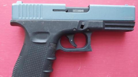 A Retay top-venting blank firer. It has a dark grey handle and trigger and a blue top section