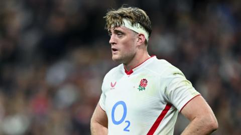 Alex Coles standing with his hands on his hips during England's match against France in the Six Nations