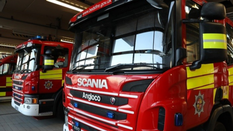 A close up of red Bedfordshire fire engines parked up and ready to attend an incident. The specialist equipment they carry is not on display.