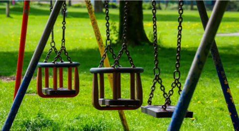 Generic image of play ground swings - two for a baby and one for an older child.