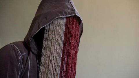 Anas Aremeyaw Anas wearing a beaded mask