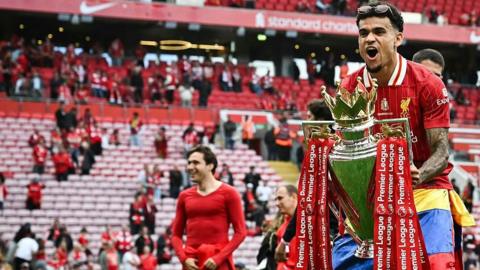 Luis Diaz celebrating with the Premier League trophy