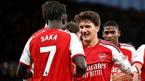 Bukayo Saka and Christos Tzolis celebrate an Arsenal goal against Coventry