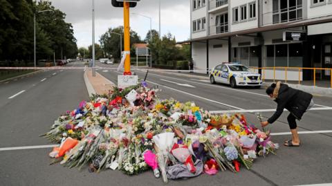 Flowers placed on a memorial in the centre of a road in Christchurch
