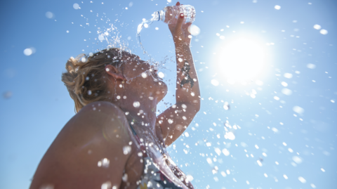 Woman pouring water on herself