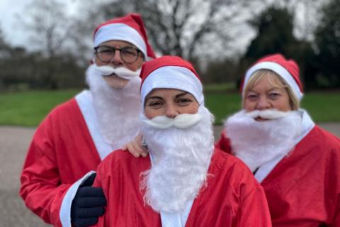 Three Santas pose for a photo at Markeaton Park