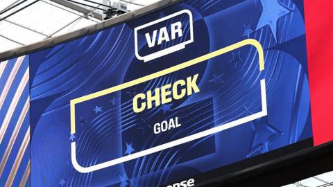 The big screen displays the VAR review after Iran's goal during the FIFA World Cup 2026 Group G match between Belgium and IR Iran at Los Angeles Stadium on June 21, 2026 in Inglewood, California.