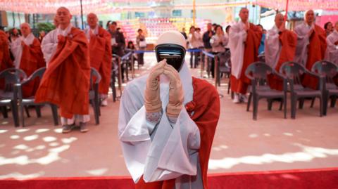 robot monk praying
