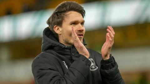 Sheffield Wednesday manager Danny Rohl applauds the away fans after his side's win at Norwich City.