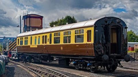 The restored buffet car sits on the railway track. It's exterior is chocolate and cream. The carriage, which dates back to the 1920s, now looks polished and clean after being restored.