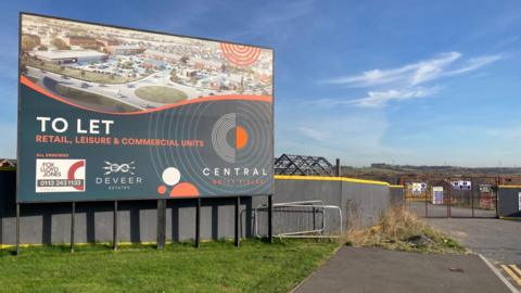 A board advertising rental opportunities for retail, leisure and commercial units on the site.