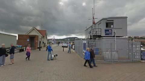 Image of Vincent's Pier in Scarborough, North Yorkshire with various people milling about 