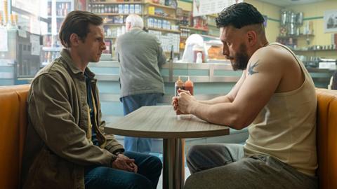 Niall (JAMIE BELL), Ruben (RICHARD GADD) sit across the table from one another