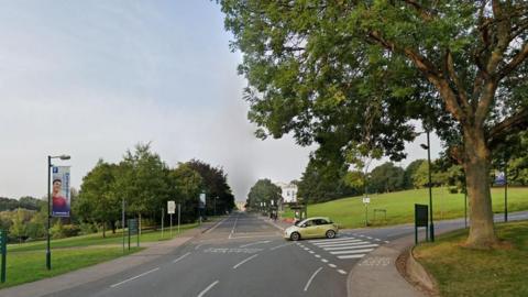 Streetview image of a road junction in a wide grassy area of the university campus